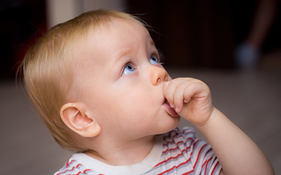 A baby sucking his thumb